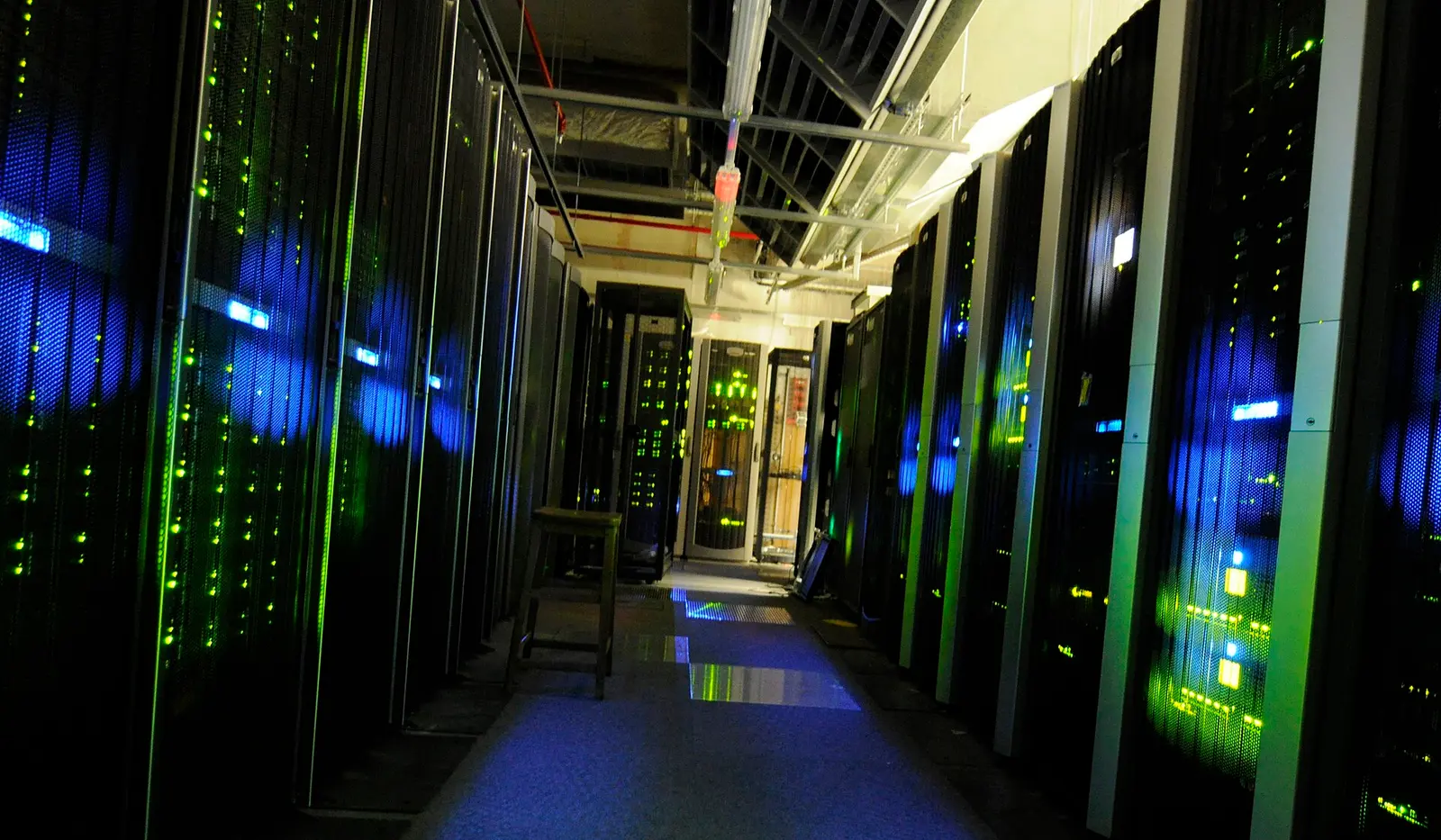 Data centre aisle with illuminated server racks